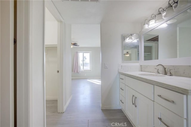 bathroom featuring vanity, hardwood / wood-style floors, and ceiling fan