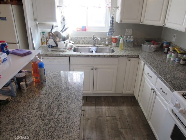 kitchen featuring dark hardwood / wood-style floors, white cabinetry, sink, light stone countertops, and white appliances