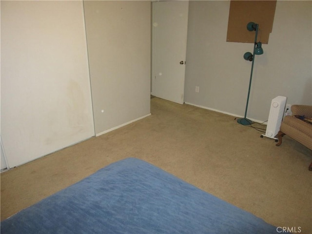 carpeted spare room featuring radiator heating unit