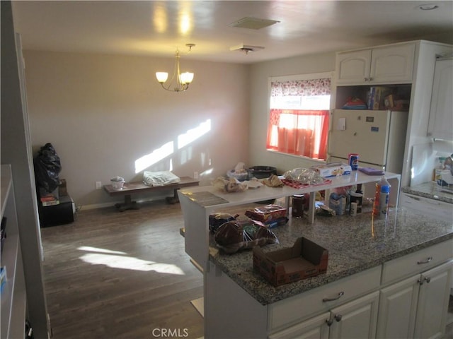 kitchen with pendant lighting, white cabinets, a chandelier, dark hardwood / wood-style flooring, and white refrigerator