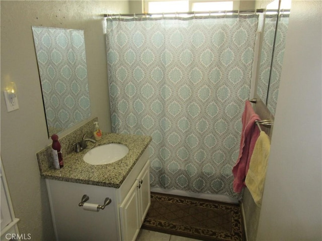 bathroom with vanity, curtained shower, and tile patterned flooring