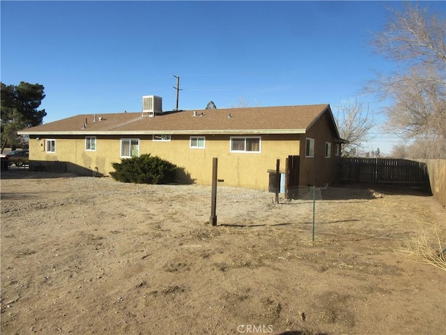 rear view of property featuring central AC