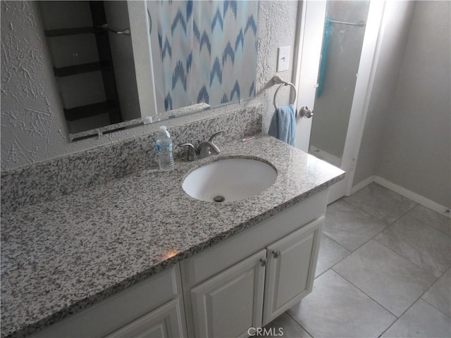 bathroom with tile patterned flooring and vanity