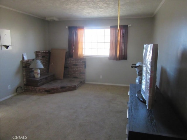 living room featuring carpet floors, ornamental molding, and a textured ceiling