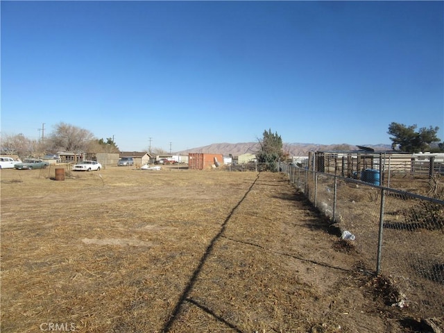 view of yard with a mountain view and a rural view