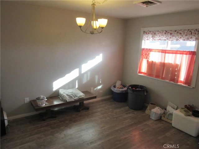 unfurnished dining area with dark hardwood / wood-style flooring and a notable chandelier