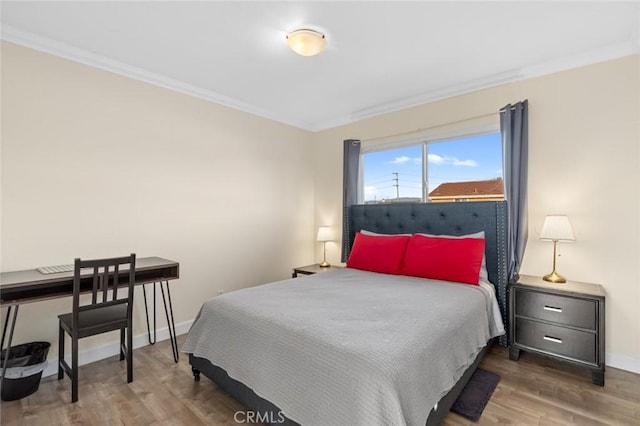 bedroom featuring crown molding and dark hardwood / wood-style flooring