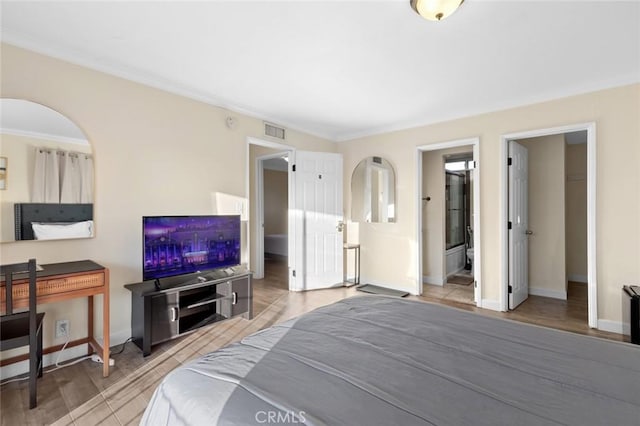 bedroom featuring crown molding and light wood-type flooring