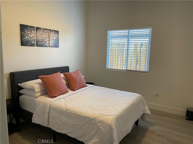 bedroom with hardwood / wood-style floors