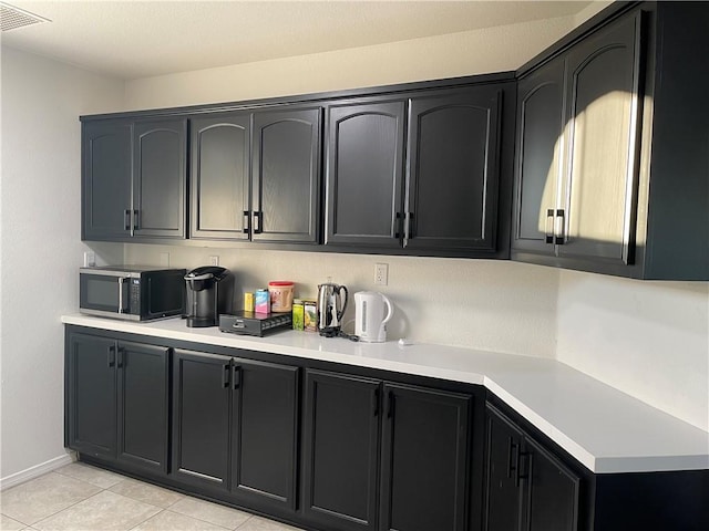 kitchen with light tile patterned flooring