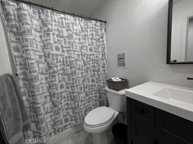 bathroom with vanity, curtained shower, and toilet