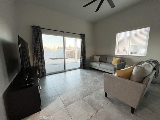 tiled living room with ceiling fan and lofted ceiling