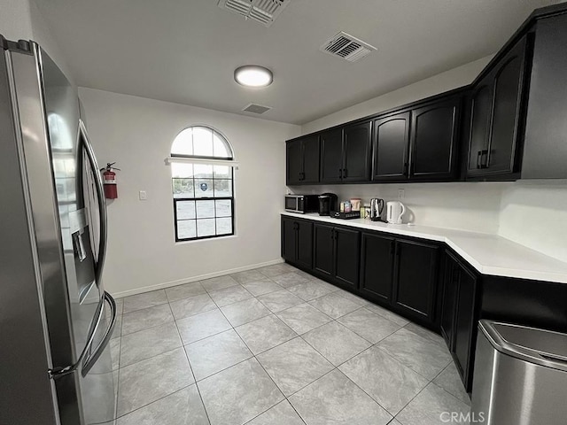 kitchen with stainless steel appliances and light tile patterned floors