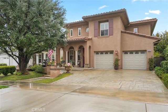 mediterranean / spanish house with a garage