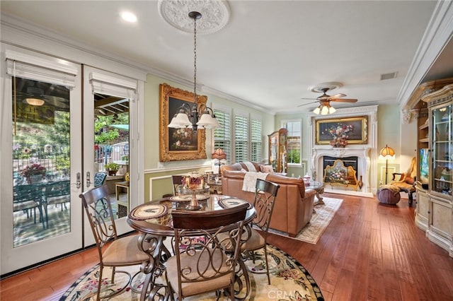 dining area with crown molding, plenty of natural light, and hardwood / wood-style floors