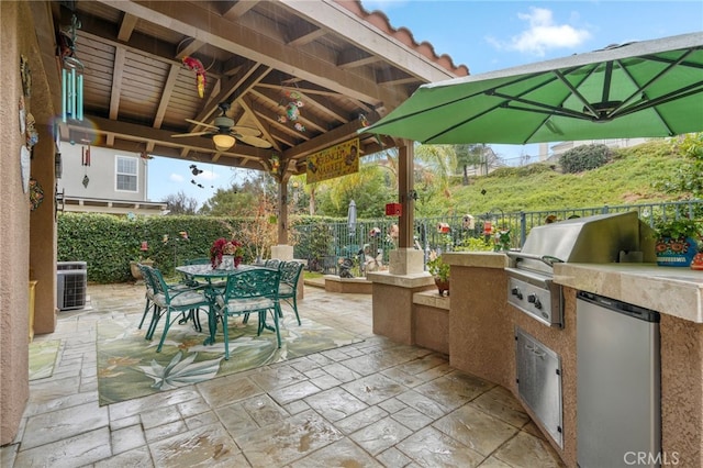 view of patio featuring an outdoor kitchen, a gazebo, central AC unit, ceiling fan, and a grill