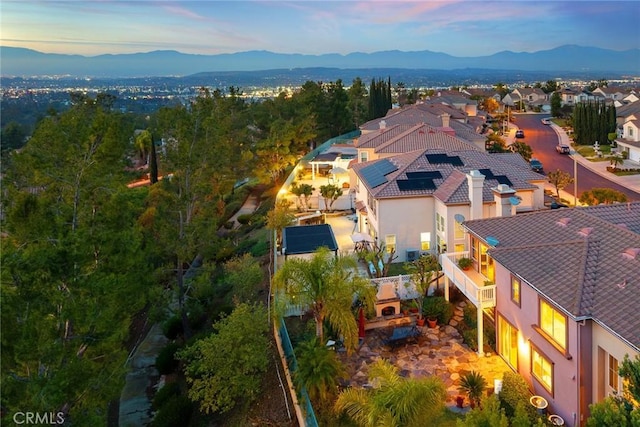 aerial view at dusk featuring a mountain view