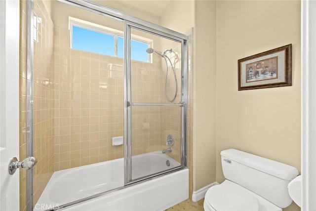 bathroom with enclosed tub / shower combo and toilet