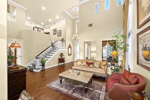 living room with crown molding, dark hardwood / wood-style flooring, and a high ceiling