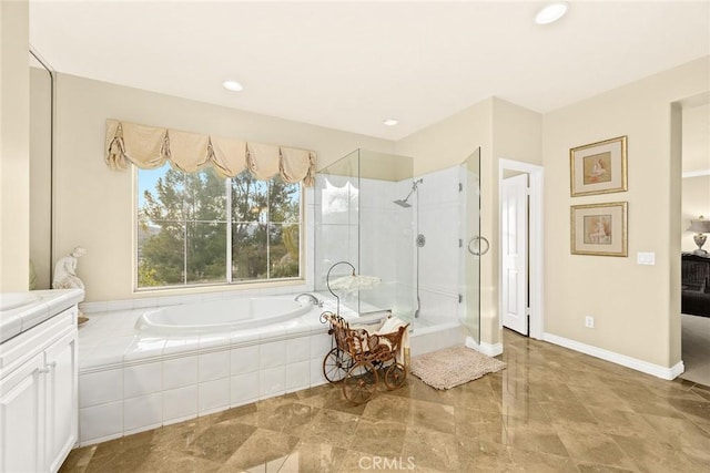 bathroom featuring vanity and independent shower and bath