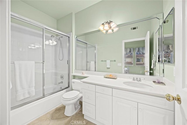 full bathroom featuring enclosed tub / shower combo, vanity, tile patterned floors, and toilet