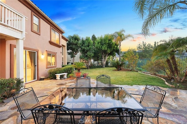 patio terrace at dusk with a yard