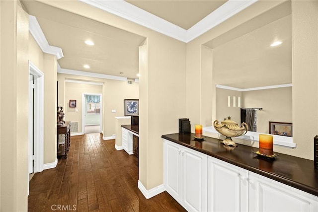 corridor featuring ornamental molding and dark hardwood / wood-style floors