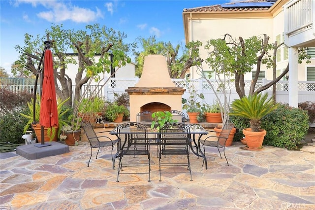 view of patio featuring exterior fireplace