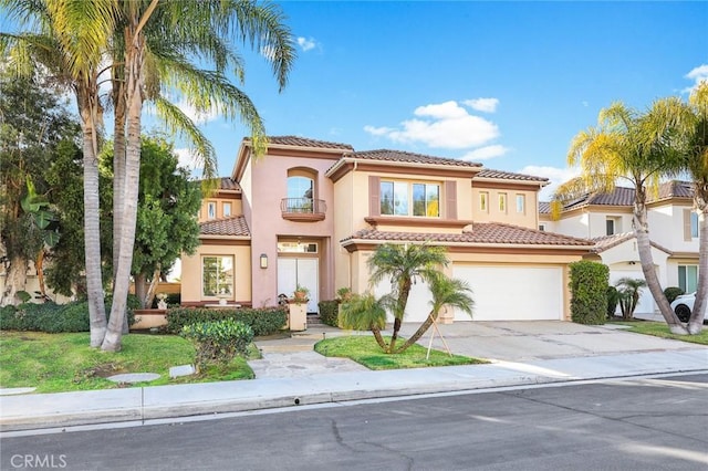 mediterranean / spanish-style house with a garage