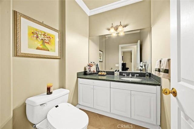 bathroom with vanity, ornamental molding, and toilet