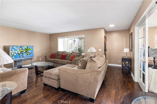 living room featuring dark hardwood / wood-style floors and a textured ceiling