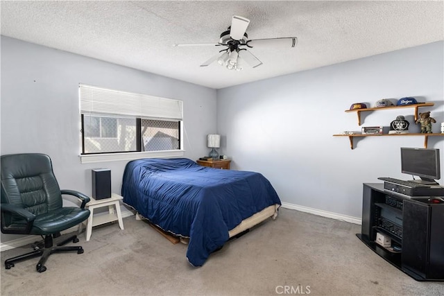 carpeted bedroom featuring ceiling fan and a textured ceiling