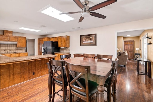 dining room featuring dark hardwood / wood-style floors and ceiling fan