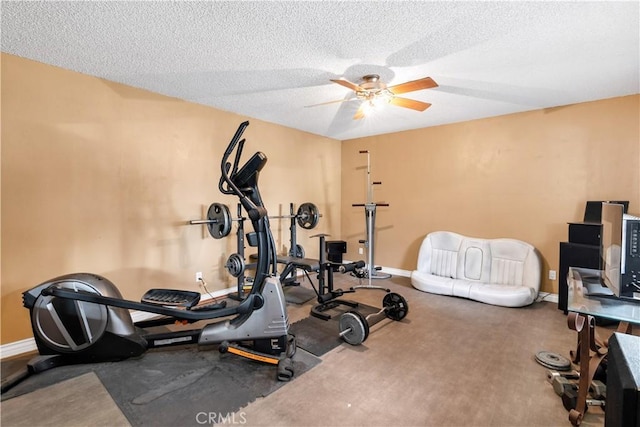 workout room featuring ceiling fan, carpet floors, and a textured ceiling