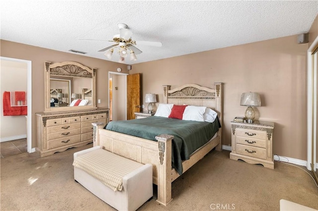 carpeted bedroom with ceiling fan and a textured ceiling