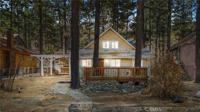 rear view of house featuring a wooden deck