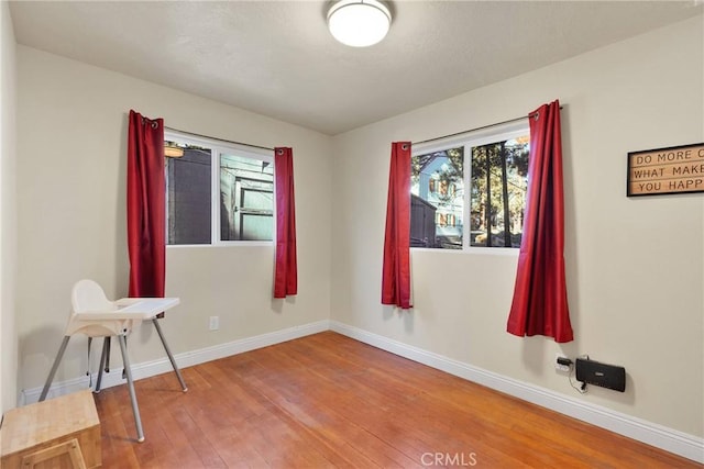 unfurnished room featuring hardwood / wood-style flooring