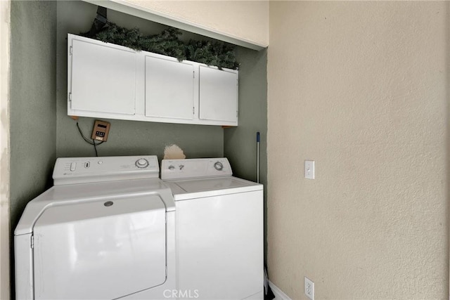 laundry area featuring cabinets and washing machine and clothes dryer