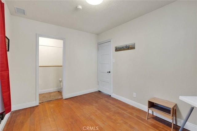 unfurnished bedroom with hardwood / wood-style flooring