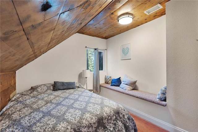 bedroom featuring hardwood / wood-style flooring, vaulted ceiling, and wood ceiling