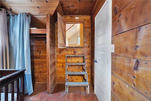 interior space with hardwood / wood-style flooring, wood ceiling, and wooden walls