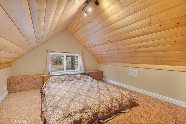 unfurnished bedroom with lofted ceiling, wooden ceiling, rail lighting, and carpet