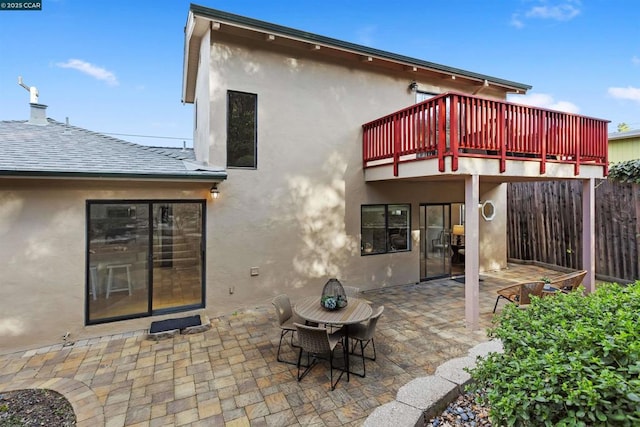 rear view of property with a patio and a balcony