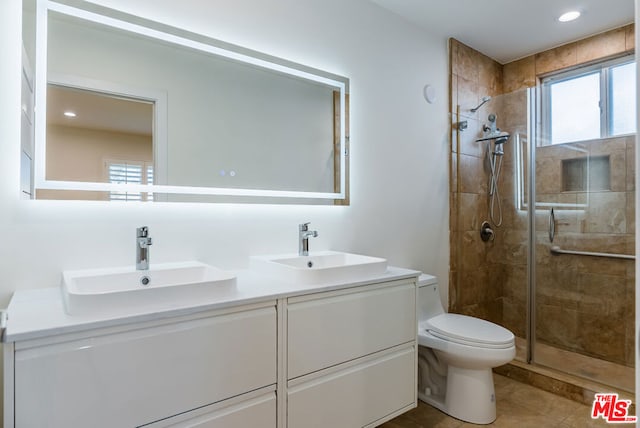 bathroom featuring walk in shower, tile patterned floors, vanity, and toilet