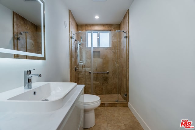 bathroom with toilet, sink, tile patterned floors, and a shower with shower door