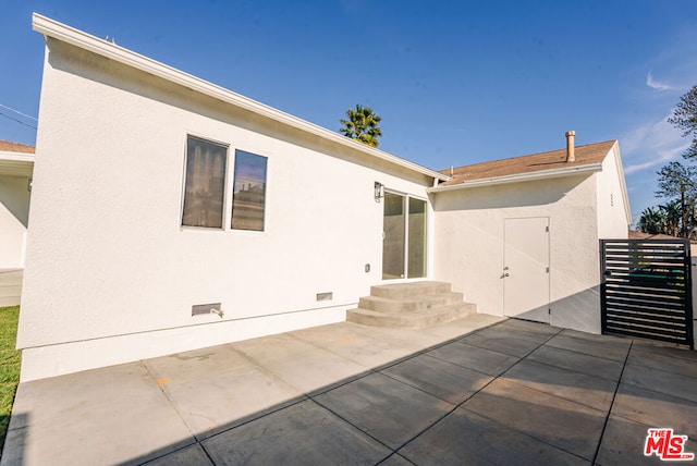 back of house with a patio