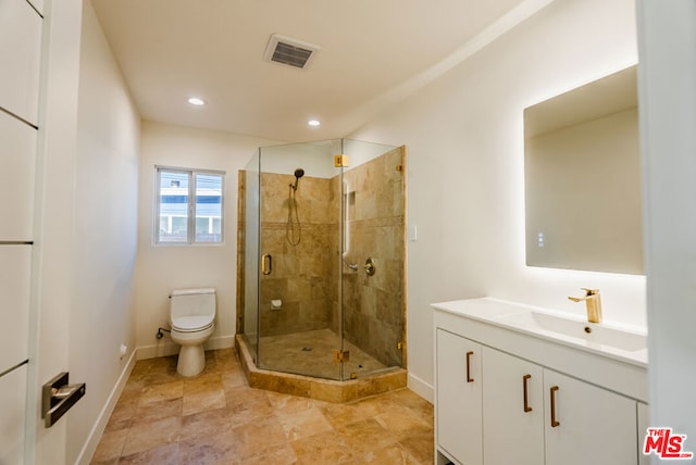 bathroom with vanity, toilet, and an enclosed shower