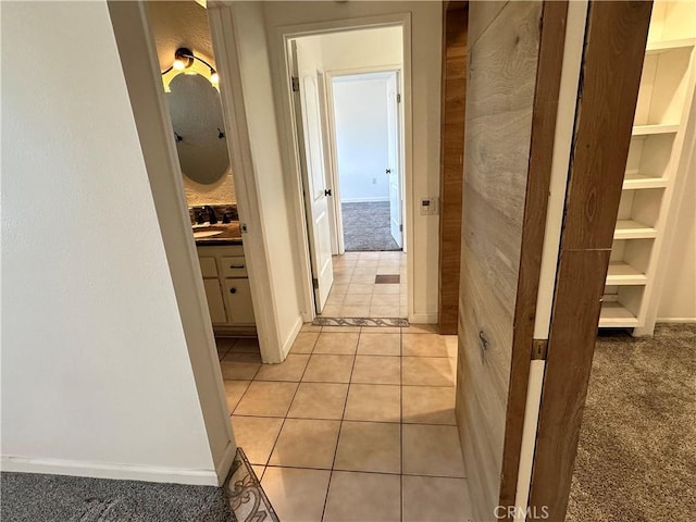 hallway featuring light colored carpet