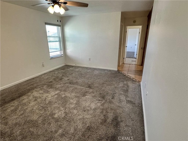 carpeted spare room with ceiling fan