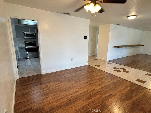 spare room featuring hardwood / wood-style flooring and ceiling fan